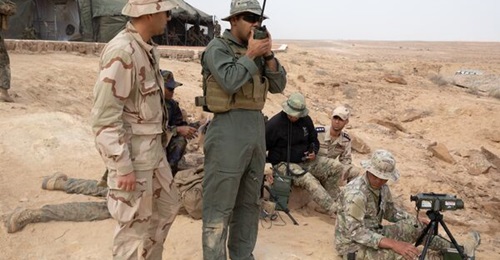 A group of soldiers that includes at least one Libyan call in air support during Exercise 'African Lion 2024' at Tunisia's Ben Ghilouf Training Area on 7 May.