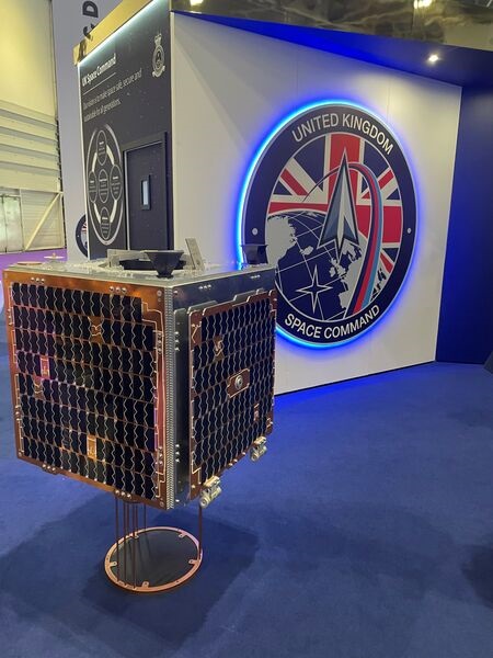 UK Space Command's debut satellite will hitch a ride on SpaceX's Transporter-11 Rideshare mission, a Falcon 9 rocket launching multiple small satellites. Pictured is a model of Tyche displayed at DSEI 2023.