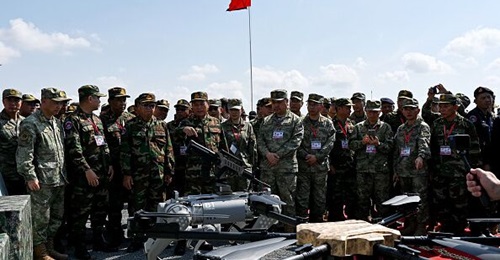 Vong Pisen, commander-in-chief of the Royal Cambodian Armed Forces, and Gao Xiucheng, deputy chief of staff of the PLA's Southern Theater Commander, attend a demonstration of a machine gun-equipped robotic dog during Exercise 'Golden Dragon'. During th...