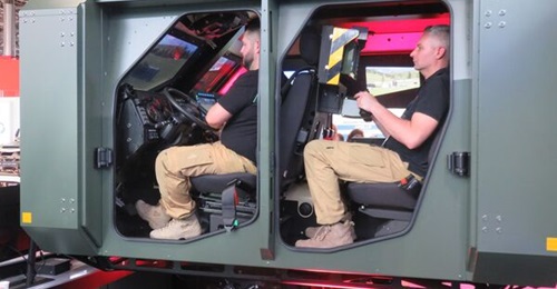 Guardiaris' Joint Light Tactical Vehicle training simulator displayed at Eurosatory 2024, with the driver and remote weapon station positions manned.