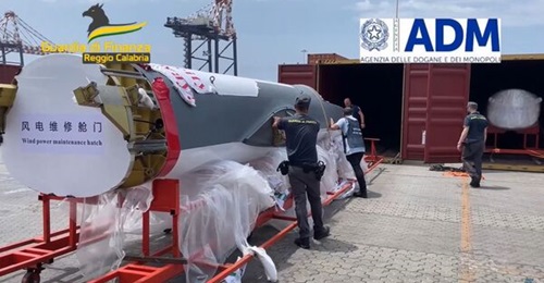 A still from a video shows Guardia di Finanza personnel unwrapping the fuselage of a UAV that was found in a container at the Italian port of Gioia Tauro.
