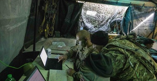 A US Army all-source intelligence technician assigned to the 2nd Battalion, 34th Armored Regiment, 1st Armored Brigade Combat Team, assists the battalion intelligence officer, during Exercise 'Allied Spirit X'  in Germany.