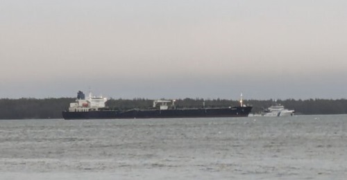 The 
        
        tanker, suspected of cutting undersea cables, is seen on 30 December 2024 anchored off Finland's Kilpilahti oil terminal with a 24-hour escort provided by the Finnish Border Guard vessel 
        
        .