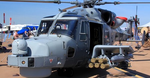 A Wildcat helicopter seen carrying the Sea Venom on the outer hardpoint of its weapons wing, with Martlets on the inner hardpoint.