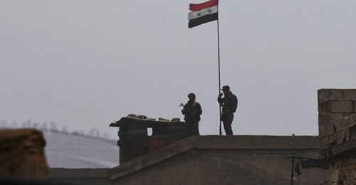 Syrian government troops are seen at a position south of Manbij on 30 December.
