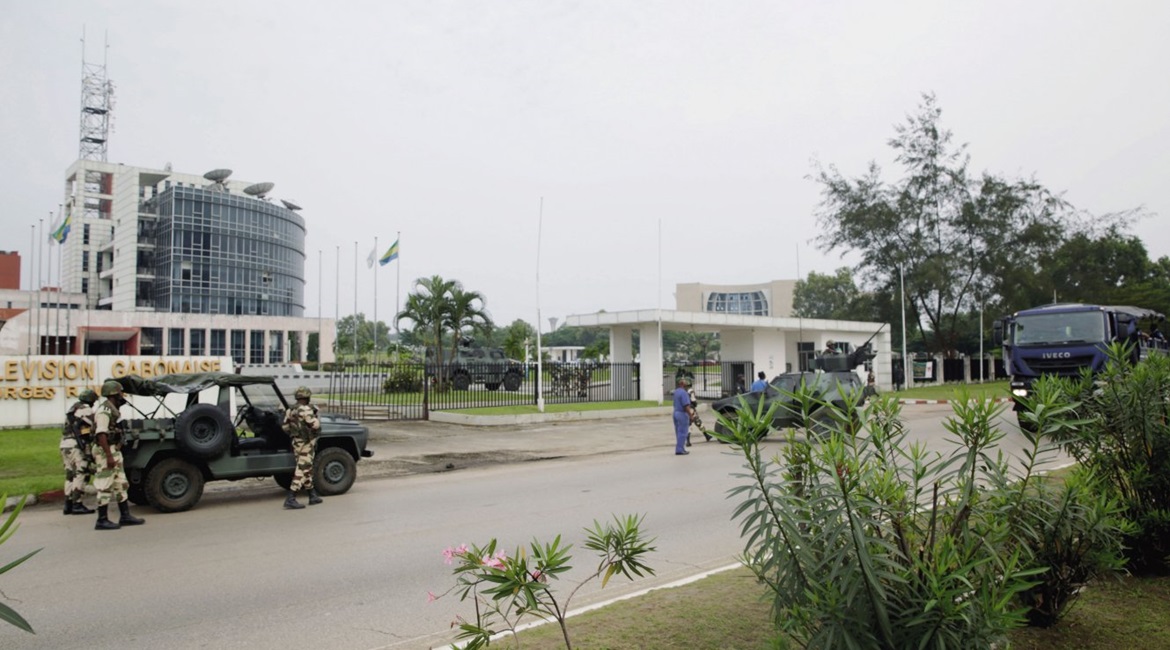 Soldiers and vehicles - including an Aravis in the background - from the Republican Guard are seen outside the Radio Télévision Gabonaise building in Libreville on 7 January.
