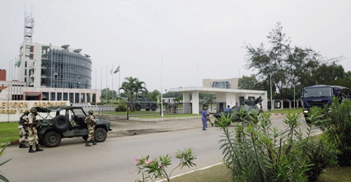 Soldiers and vehicles - including an Aravis in the background - from the Republican Guard are seen outside the Radio Télévision Gabonaise building in Libreville on 7 January.