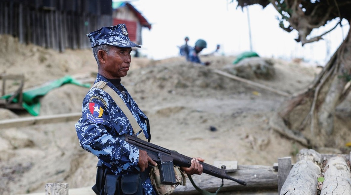 A Myanmar border guard policeman patrols a police station in Buthidaung on 7 January following attacks launched three days earlier by Arakan Army insurgents.