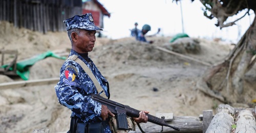 A Myanmar border guard policeman patrols a police station in Buthidaung on 7 January following attacks launched three days earlier by Arakan Army insurgents.