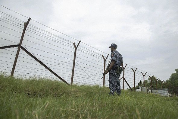 Myanmar border police patrol the fence in the ’no man’s land’ zone between Myanmar and Bangladesh in Rakhine state during a government-organised visit for journalists on 24 August 2018. (Phyo Hein Kyaw/AFP/Getty Images)