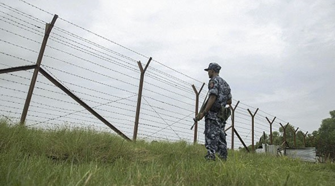 Myanmar border police patrol the fence in the 'no man's land' zone between Myanmar and Bangladesh in Rakhine state during a government-organised visit for journalists on 24 August 2018.