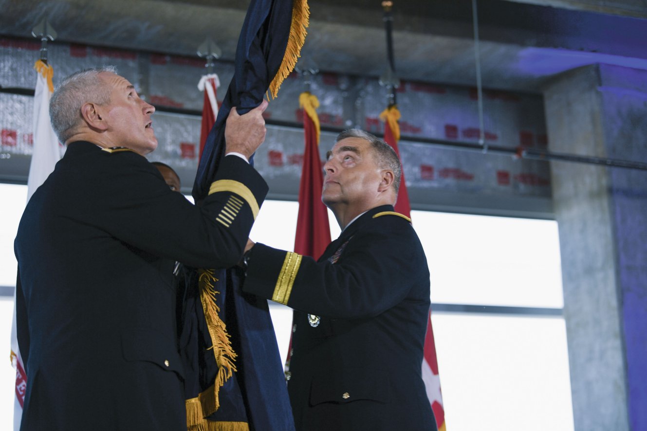 US Army General Mike Murray, commander of Army Futures Command, and Chief of Staff of the Army General Mark Milley unfurl the Army Futures Command flag during a ceremony last August. Gen Milley has been nominated to be the next chairman of the Joint Chiefs of Staff.  (US Army )