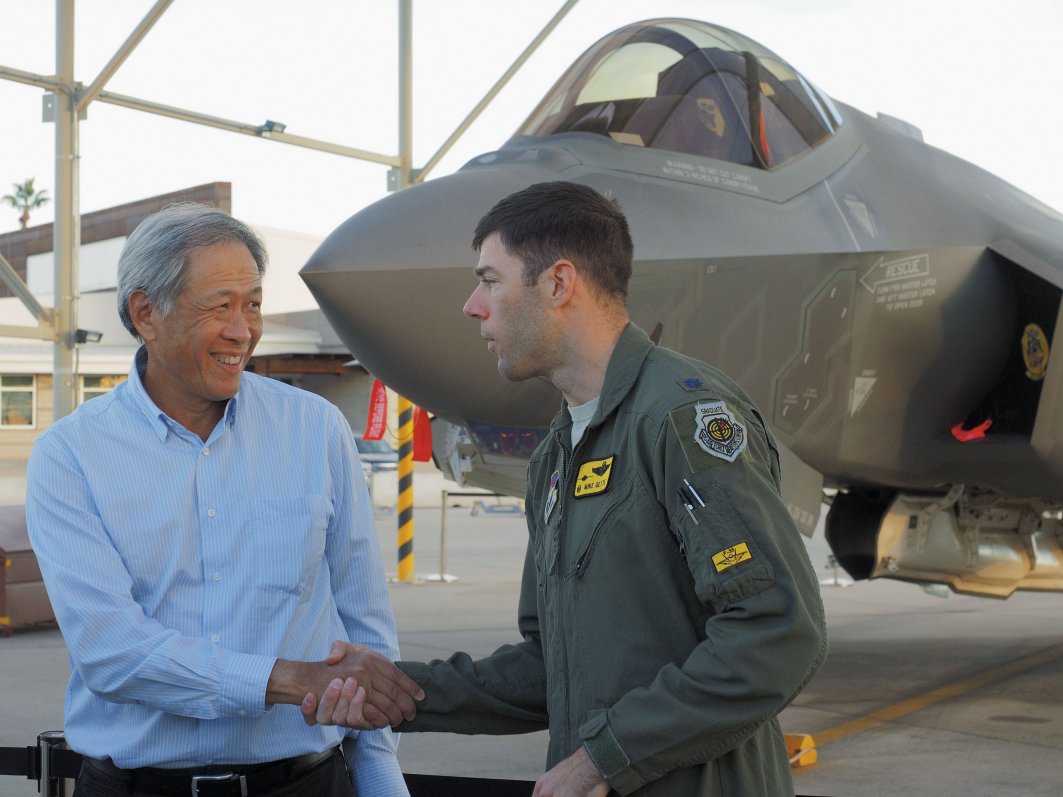 Singapore’s defence minister, Ng Eng Hen, receives a briefing on the conventional take-off and landing F-35A at Luke Air Force Base, Arizona, on the sidelines of Exercise ‘Forging Sabre’ in December 2015. The country has announced that it has selected an unspecified variant of the aircraft for further evaluation. (IHS Markit/Kelvin Wong)