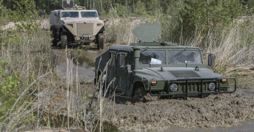 An AM General Humvee and a Sisu Auto GTP under evaluation in Latvia in May 2018.