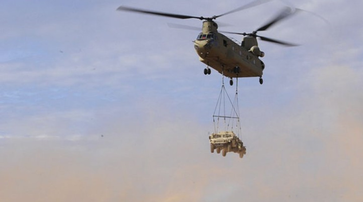 A CH-47 Chinook transports a Humvee during a sling load operation in July 2017. The US Army Reserve is set to acquire 60 JLTVs to train on in preparation for phasing out the Humvee.
