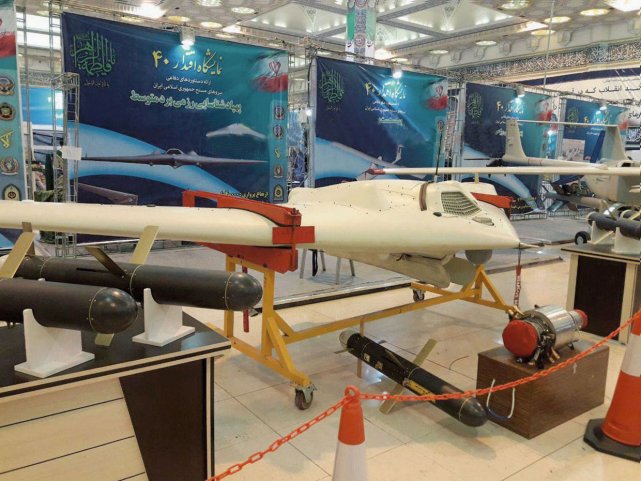 The Saegheh-2 is seen displayed on a stand with the doors of its weapons bay open. Guided weapons and what might be the UAV's engine were displayed nearby. (Tasnim News Agency)