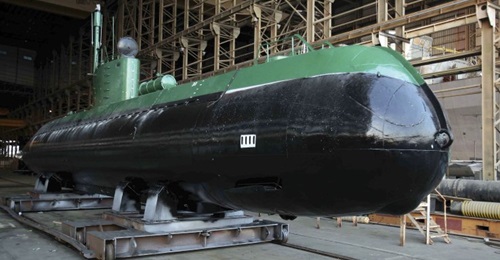 A Ghadir submarine is seen out of the water. It is unclear if the submarine-launched missile is a short-range weapon developed for the class or whether one of the midgets is being used as a test platform for a missile designed for the new Fateh class.