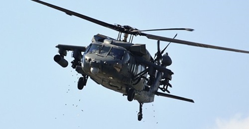 A weaponised UAE Joint Aviation Command UH-60M fires its GAU-19 miniguns during the IDEX 2019 dynamic display.
