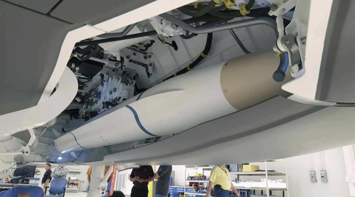 A model AARGM-ER missile being installed for a fit check into an F-35C weapons bay simulator.