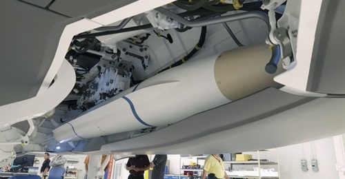 A model AARGM-ER missile being installed for a fit check into an F-35C weapons bay simulator.