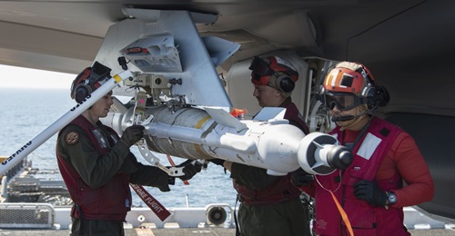 A GBU 49 is loaded onto an F-35B on the flight deck of Wasp-class amphibious assault ship USS 
        
         (LHD 2) on 12 December 2018. The USN modified an adapter, the white collar being removed by USMC Corporal Randle Lane (left), to l...