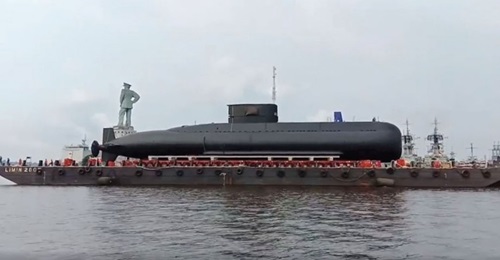 , seen here on an intermediary barge while on its way to an alternative launch site.