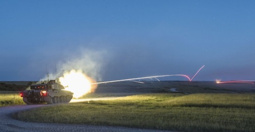A Challenger 2 during the night firing of kinetic energy rounds down range.