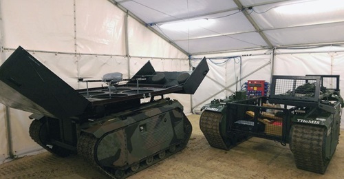 The two configurations of the THeMIS that participated in Exercise 'Autonomous Warrior': the one on the left is equipped with the KX-4 LE Titan unmanned aerial vehicle (UAV) while the one on right is the logistics version that can carry a payload of 75...