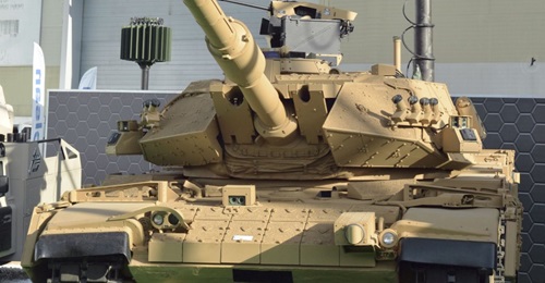 The latest upgraded M60TM tank for the Turkish Land Forces Command, fitted with a retractable mast-mounted sensor pack and one of the Pulat active protection system munition modules on the front of the vehicle.