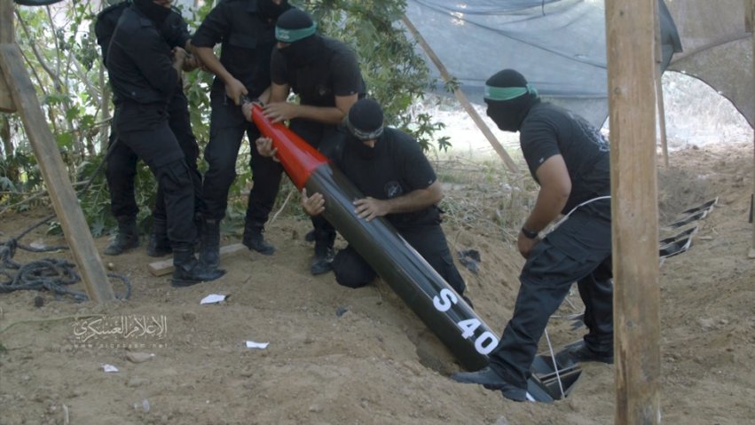 A still from a video released by the Al-Qassam Brigades on 6 May 2019 shows Palestinian militants lowering an S 40 rocket into one of several launchers that have been buried in the ground. (Al-Qassam Brigades)