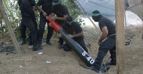 A still from a video released by the Al-Qassam Brigades on 6 May 2019 shows Palestinian militants lowering an S 40 rocket into one of several launchers that have been buried in the ground.