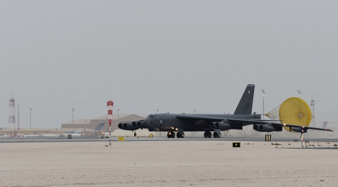 A US Air Force B-52H Stratofortress bomber taxis on a runway at an undisclosed base in the CENTCOM area of responsibility on 8 May. A Qatari C-17 transport aircraft and hangars identical to those at Qatar's Al-Udeid Air Base can be seen in the background.