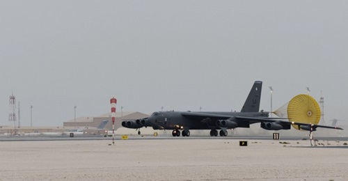 A US Air Force B-52H Stratofortress bomber taxis on a runway at an undisclosed base in the CENTCOM area of responsibility on 8 May. A Qatari C-17 transport aircraft and hangars identical to those at Qatar's Al-Udeid Air Base can be seen in the background.