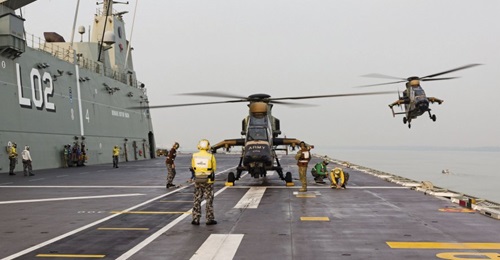 An Australian Army Armed Reconnaissance Helicopter lands on HMAS Canberra's flight deck during Indo-Pacific Endeavour 2019