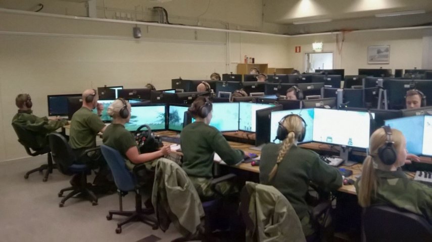 A fixed StrisimPC installation. A trainee can be seen with a steering wheel on the left. (Swedish Army)