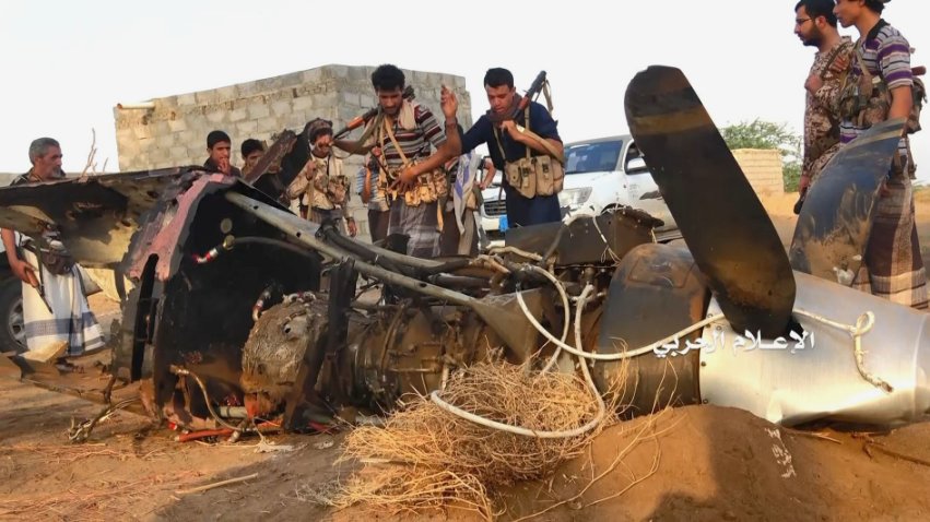 Ansar Allah fighters inspect the wreckage of a UAV that was shot down in Yemen on 6 June. CENTCOM has confirmed it was a US-operated MQ-9. (Al-Masirah TV)