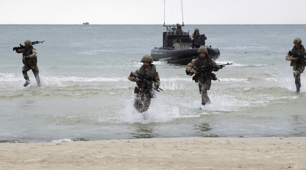 Marines disembark from raiding craft during an amphibious demonstration at Palanga Beach, Lithuania held as part of 'BALTOPS 2019'.