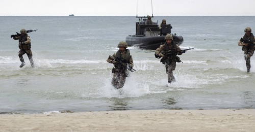 Marines disembark from raiding craft during an amphibious demonstration at Palanga Beach, Lithuania held as part of 'BALTOPS 2019'.