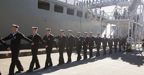 The crew of HMAS 
        
         march off the ship for the last time during the AOR's decommissioning ceremony on 29 June at Fleet Base East, Sydney.