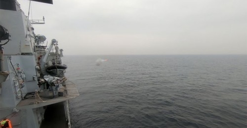 A Martlet missile being fired from a five-canister LMM/Martlet pannier co-mounted with the MSI-Defence Systems 30 mm DS30M Mark 2 gun on the RN Type 23 frigate HMS 
        
         at a fast moving FIAC-representative speedboat off the MOD A...