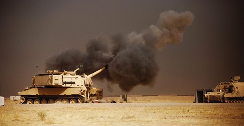 A US Army M109A6 Paladin howitzer conducts a fire mission at Qayyarah West Airfield in Iraq as coalition forces move towards Mosul. The army's ERCA effort is designed to increase the M109A7's range and rate of fire. (US Army)