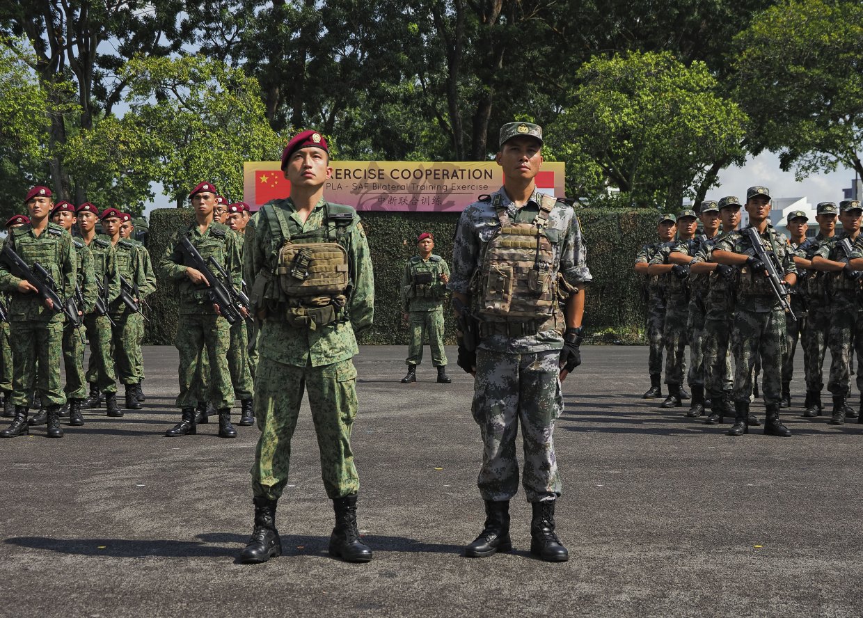 Participating units from the Singapore Armed Forces and the People’s Liberation Army stand at attention during the opening ceremony of Exercise ‘Co-operation 2019’. (IHS Markit/Kelvin Wong)