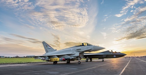 A Eurofighter Typhoon sits alongside a concept model of Tempest, a vision of the UK's future combat aircraft, at BAE Systems' site in Warton, Lancashire.