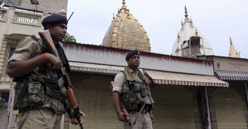 Indian security personnel stand guard next to closed shops in Jammu on 7 August. New Delhi has deployed additional security forces to Jammu and Kashmir following its 5 August decision to revoke the state's special constitutional status.