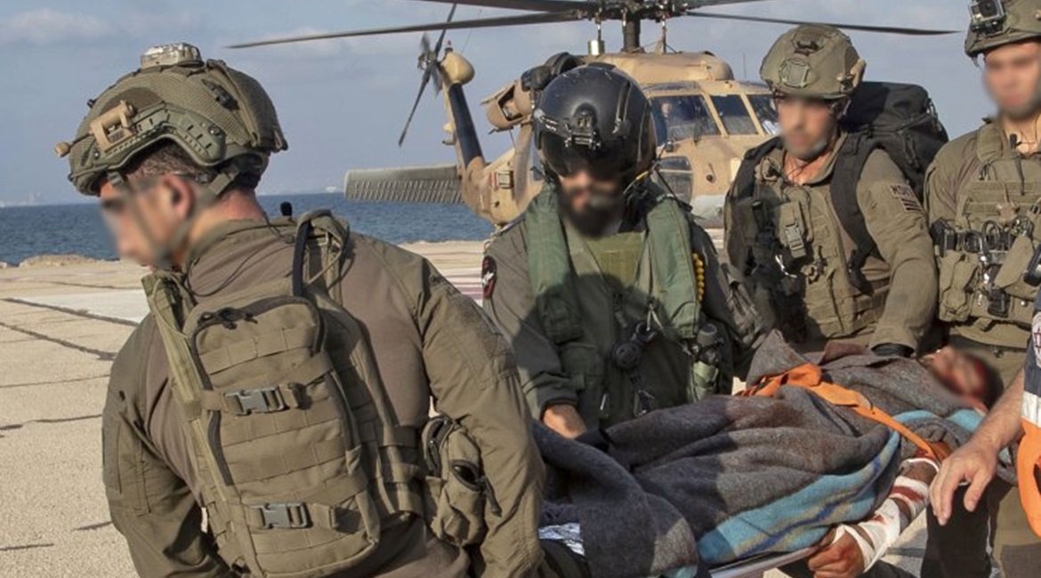 Israeli soldiers unload what appeared to be a casualty at Ramban hospital in Haifa after a Hizbullah missile attack on the Lebanese border. The IDF subsequently announced the attack caused no casualties.