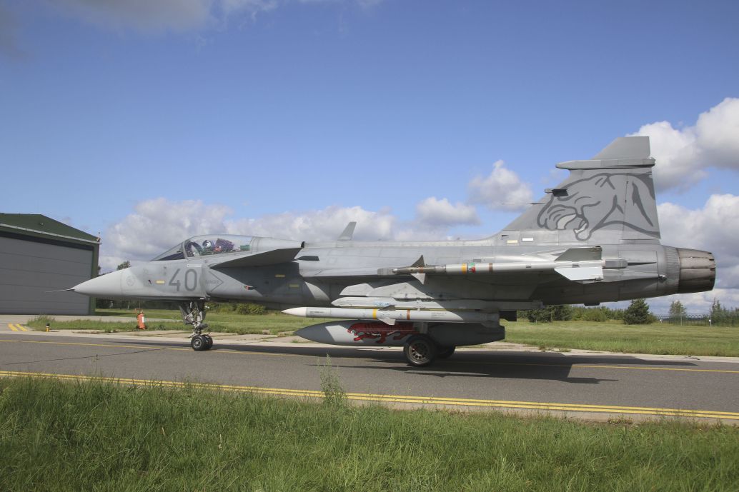 A Hungarian Air Force JAS 39C Gripen, armed with two AIM-120C5 AMRAAMs and two AIM-9L Sidewinders, taxies to its alert barn after a scramble. (Alan Warnes)
