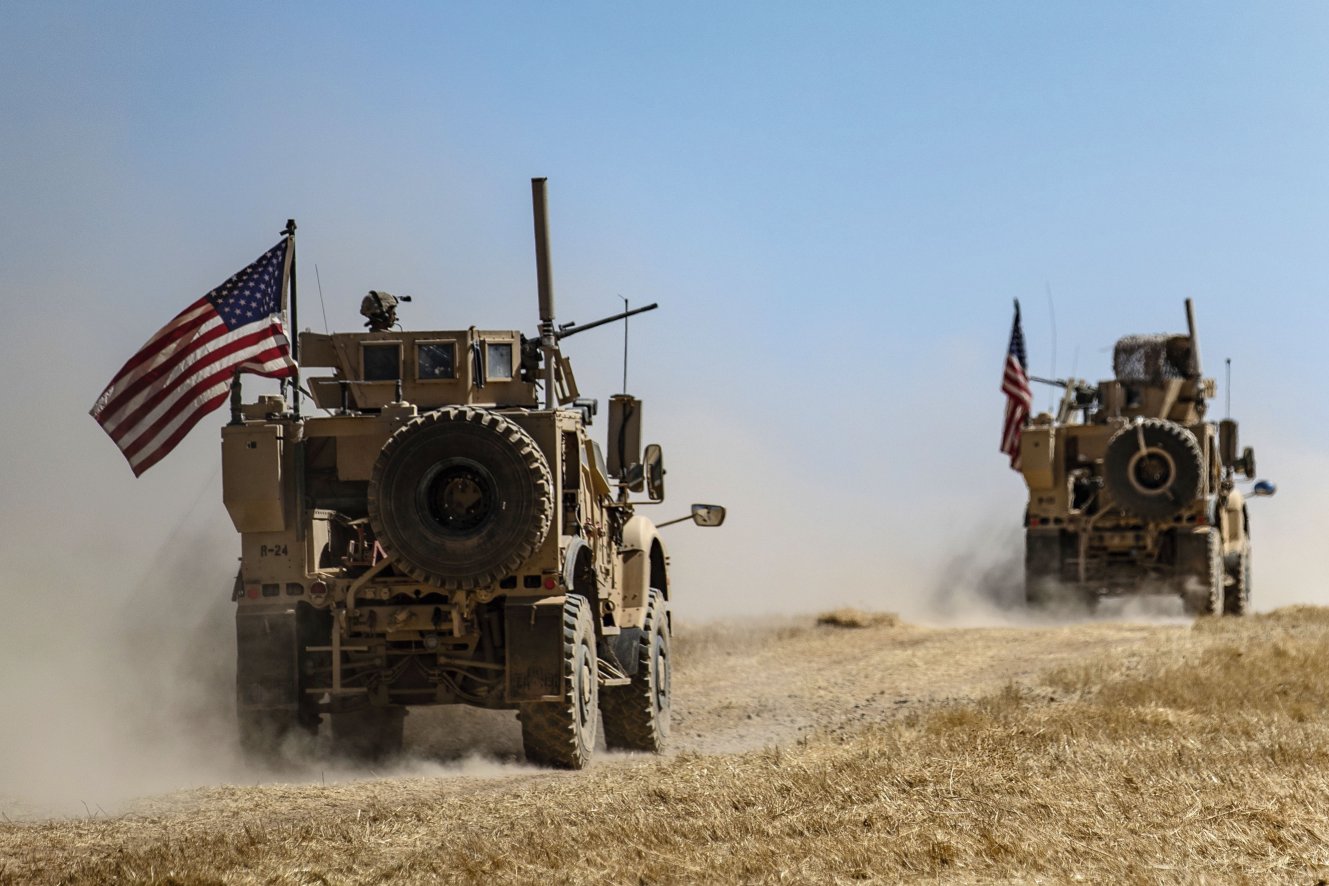 A US military convoy participates in joint patrol with Turkish troops in the Syrian village of al-Hashisha on the outskirts of Tal Abyad town along the border with Turkish troops on 8 September. The US and Turkey have begun joint patrols in northeastern Syria aimed at easing tensions between Ankara and US-backed Kurdish forces. (Delil Souleiman/AFP/Getty Images)