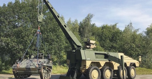 The FFG Boxer Armoured Recovery Module lifting a Wiesel light armoured vehicle.