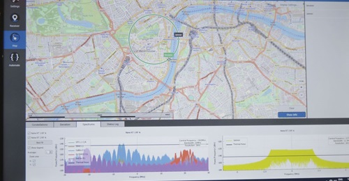 The Orolia GSG-8 GNSS simulation and test platform showing a simulated unmanned aerial vehicle (UAV) with a GNSS receiver flying a circular pattern with a simulated static jammer. The graphs at the bottom of the screen show signals from the different G...