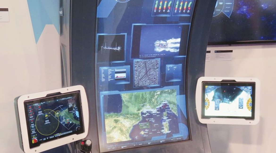 Pictured here is the Thales Mission@ISR concept demonstrator displayed at DSEI 2019. On the single curved screen from the top are: circular menu; mission data for two UAVs; two electro-optical sensor feeds; AIS track data; overhead imagery; and overall...